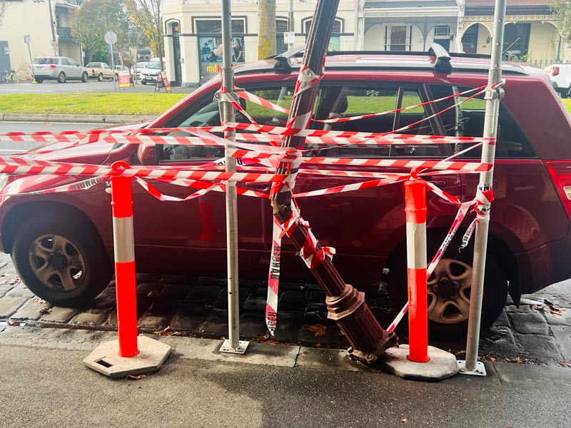 Collapsed column outside home posing risk to nearby cars and pedestrians